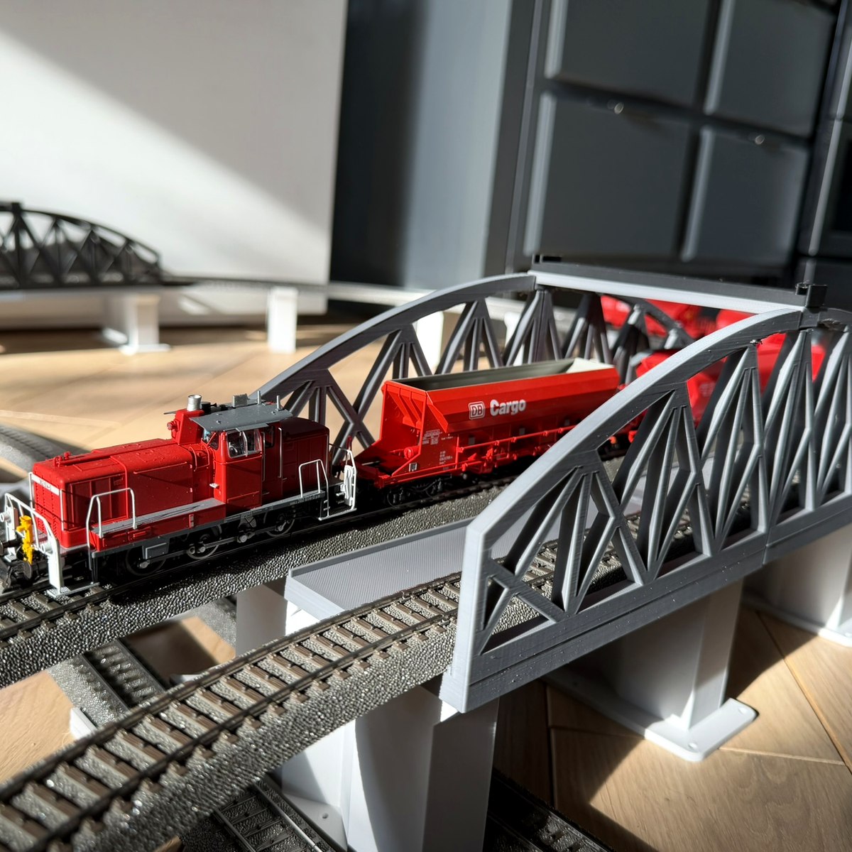 Real print: light grey bridge in sunlight, DB Cargo train crossing