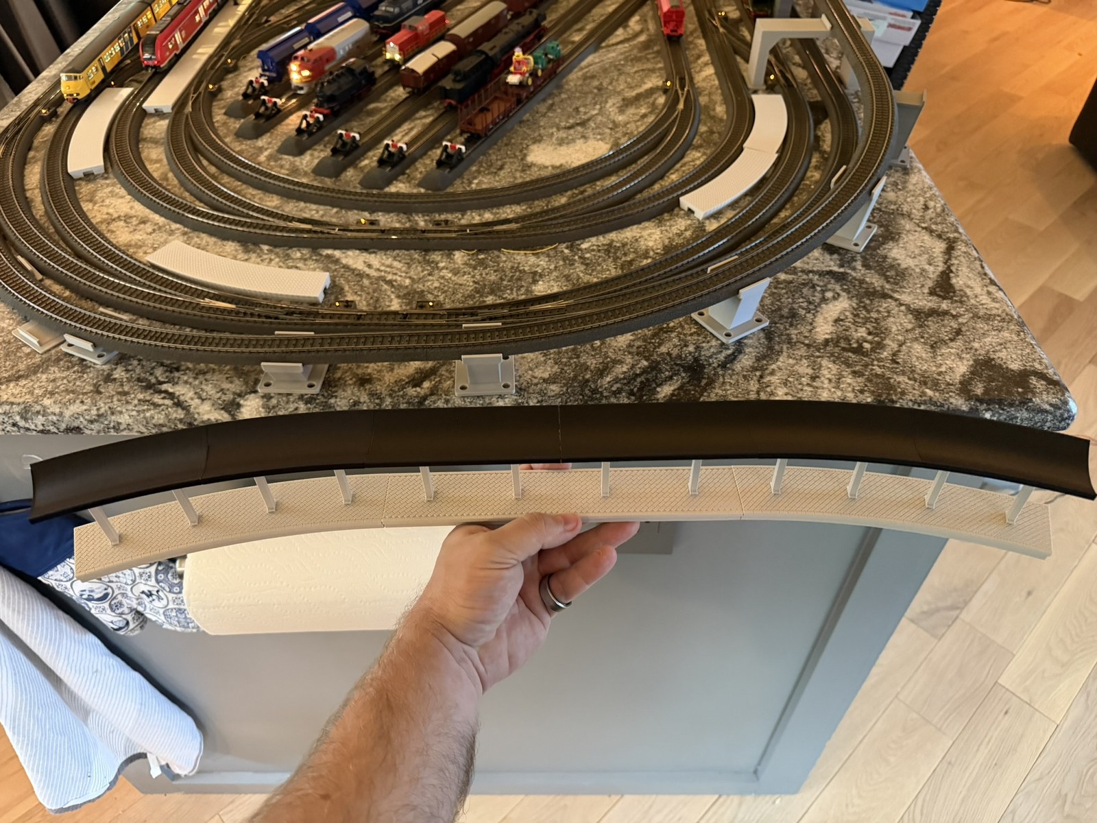 Real print: full modular station assembly held above the layout