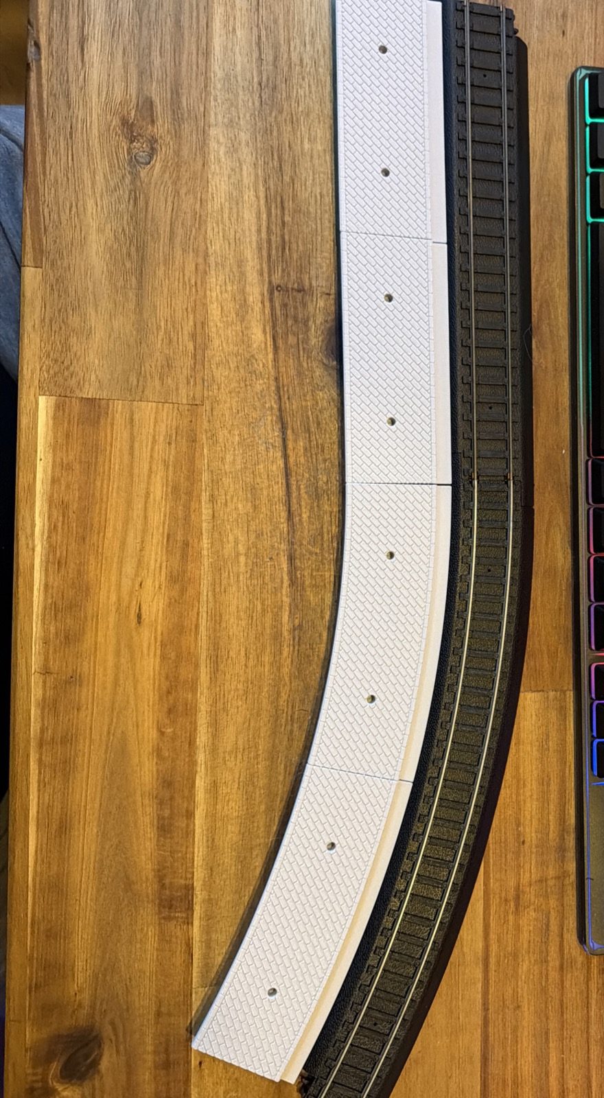Real print: paved curved platform modules laid out beside a Power-Loc 22 in curve