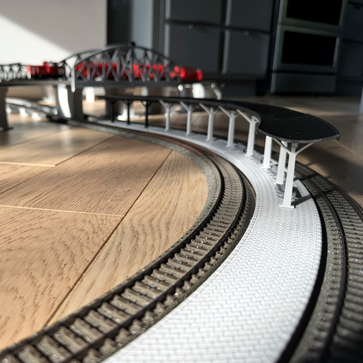 Real print: track-level view along the curved station canopy