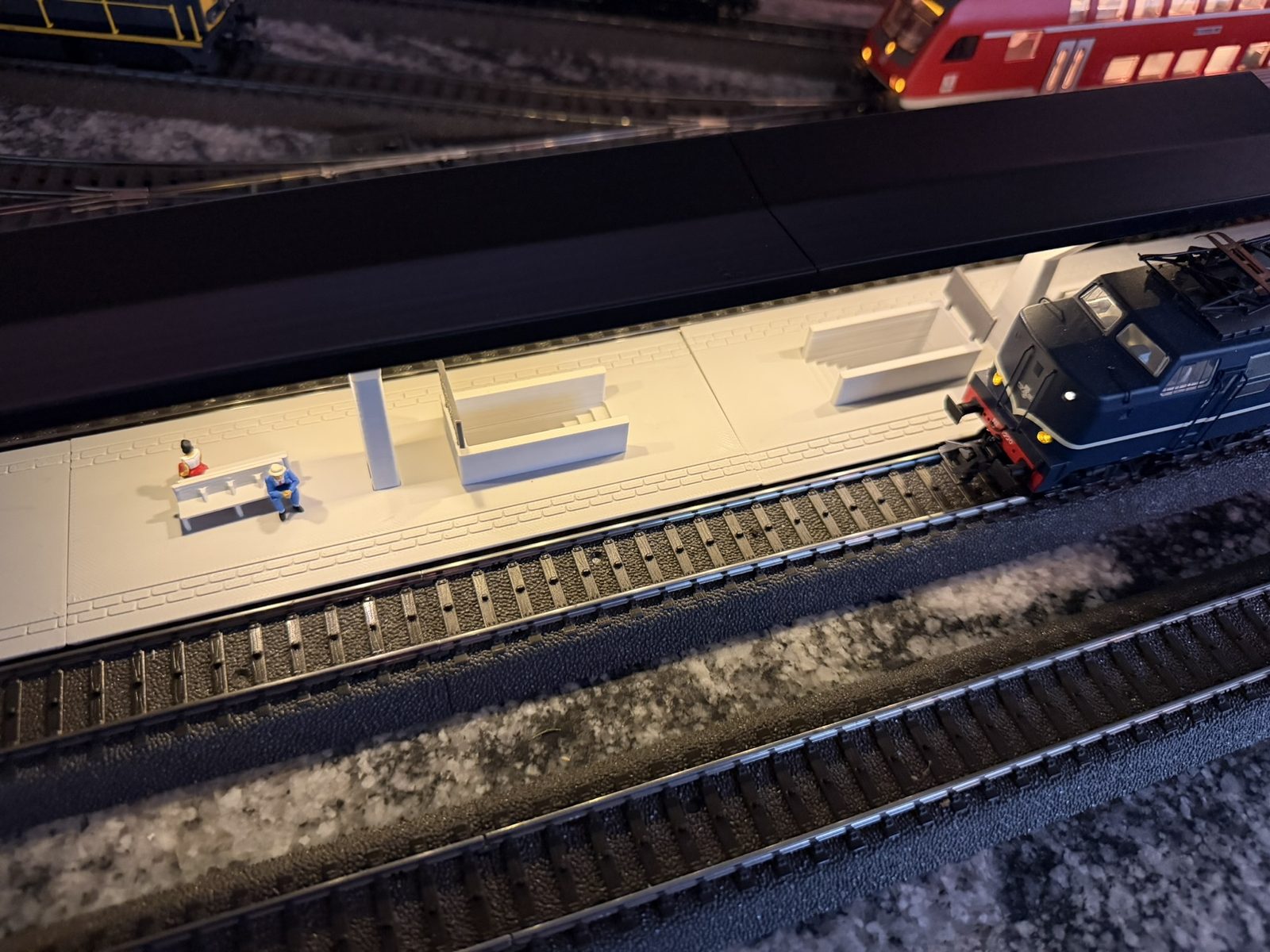 Real print: a locomotive arriving along the V roof station platform, seen from the platform end